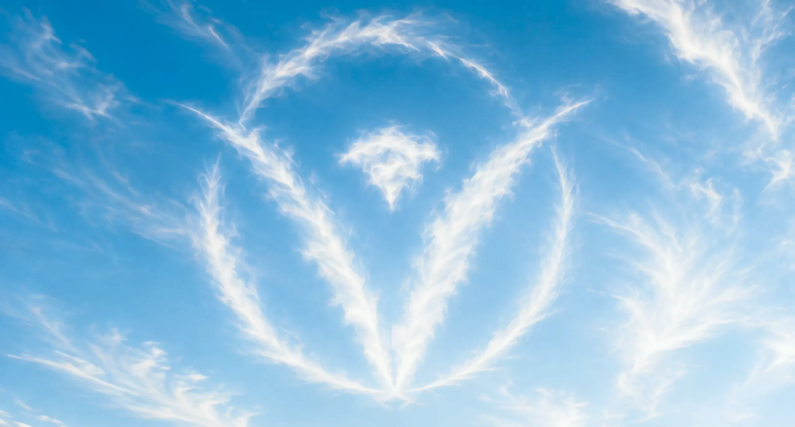 A circular cloud formation resembling the Vivo Healthcare mark, drifting in a blue sky